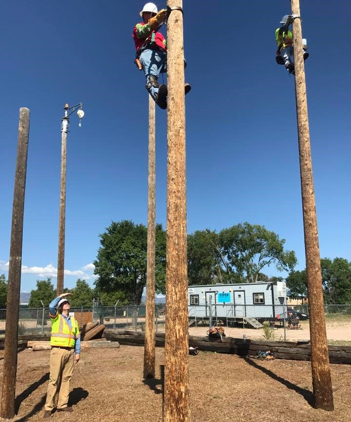 David Swisher overseeing the training of Comcast field technicians on telephone poles.